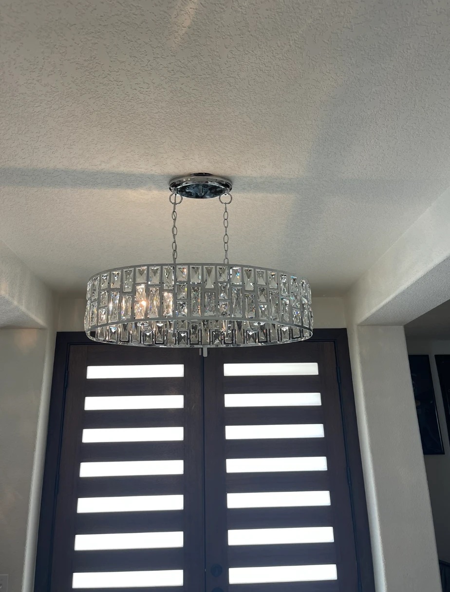 Crystal chandelier hung over a double-door entryway